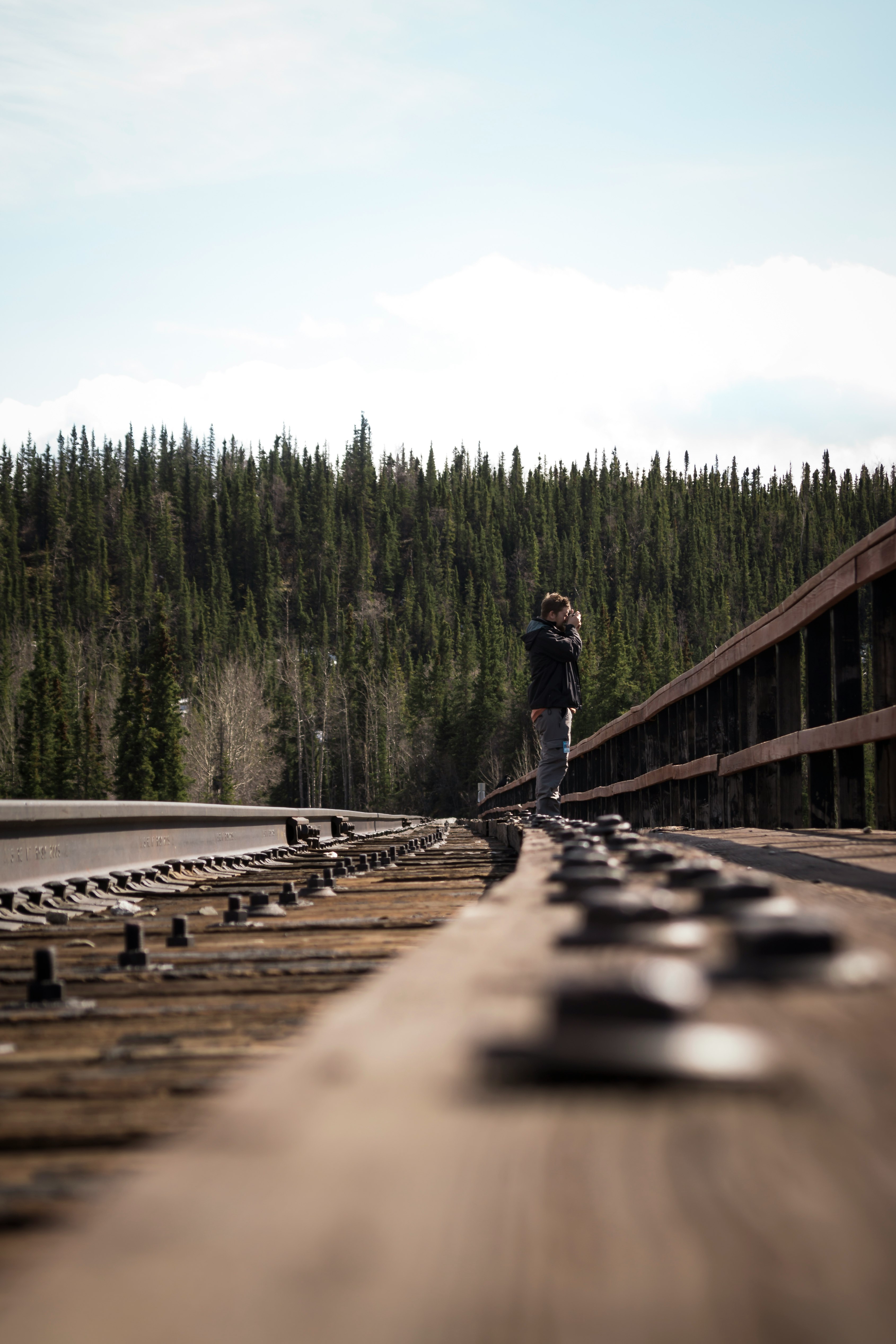 selective focus photography of person standing on train railway